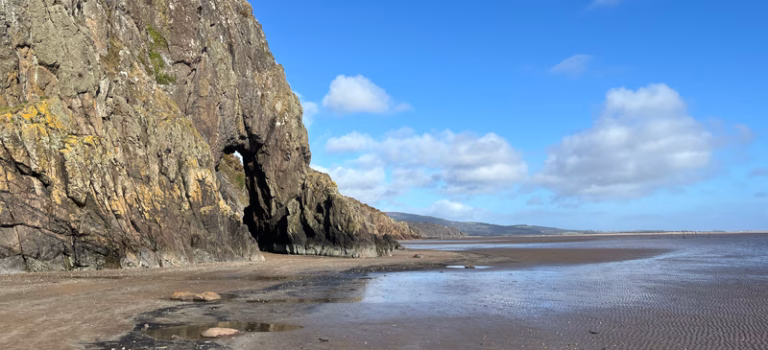 The Needle's Eye natural rock arch near Sandyhills Beach on the Solway Coast, accessible at low tide