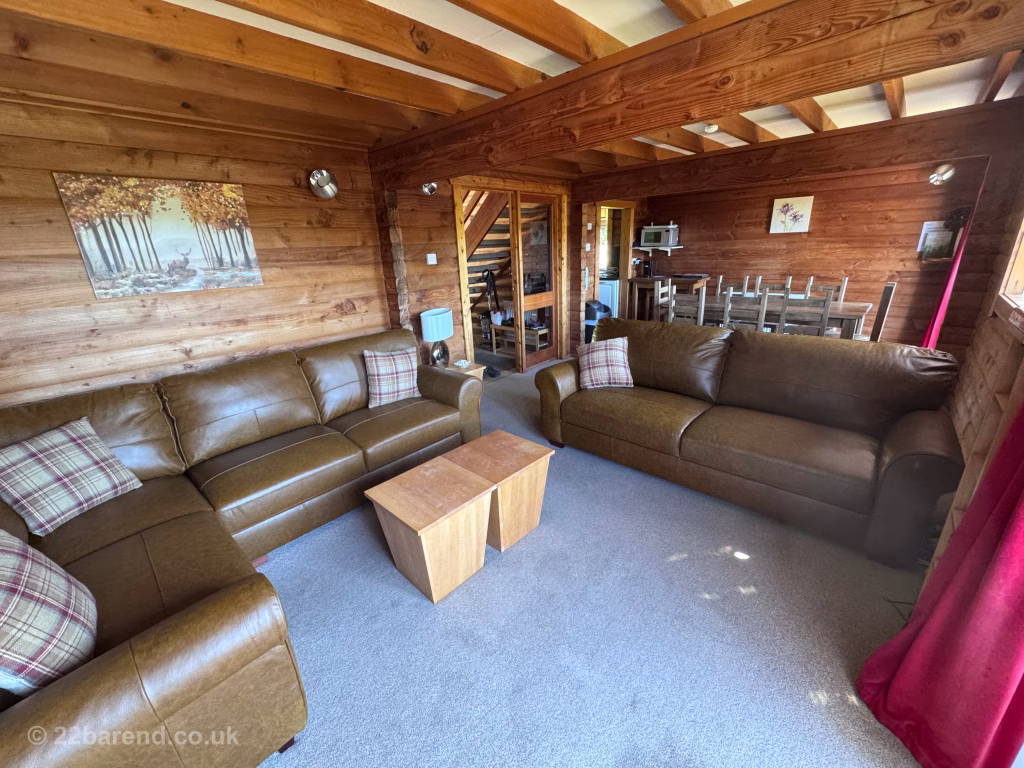 View across the room of the sofas and dining table at Serenity 22 Barend